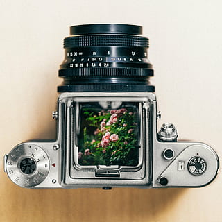 grey and black DSLR camera on brown wooden surface, silver HD wallpaper