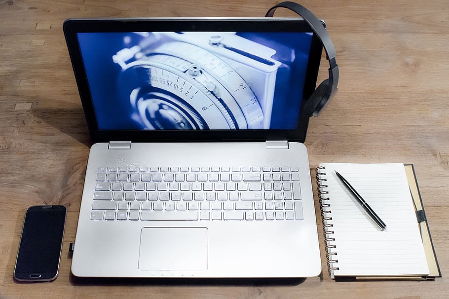 silver and black laptop computer beside black Android smartphone HD wallpaper