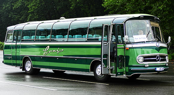 close-up photography of green and black Mercedes-Benz bus on concrete road at daytime HD wallpaper