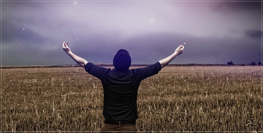 man standing on dried leaf field raising hand, sky, love, cloud