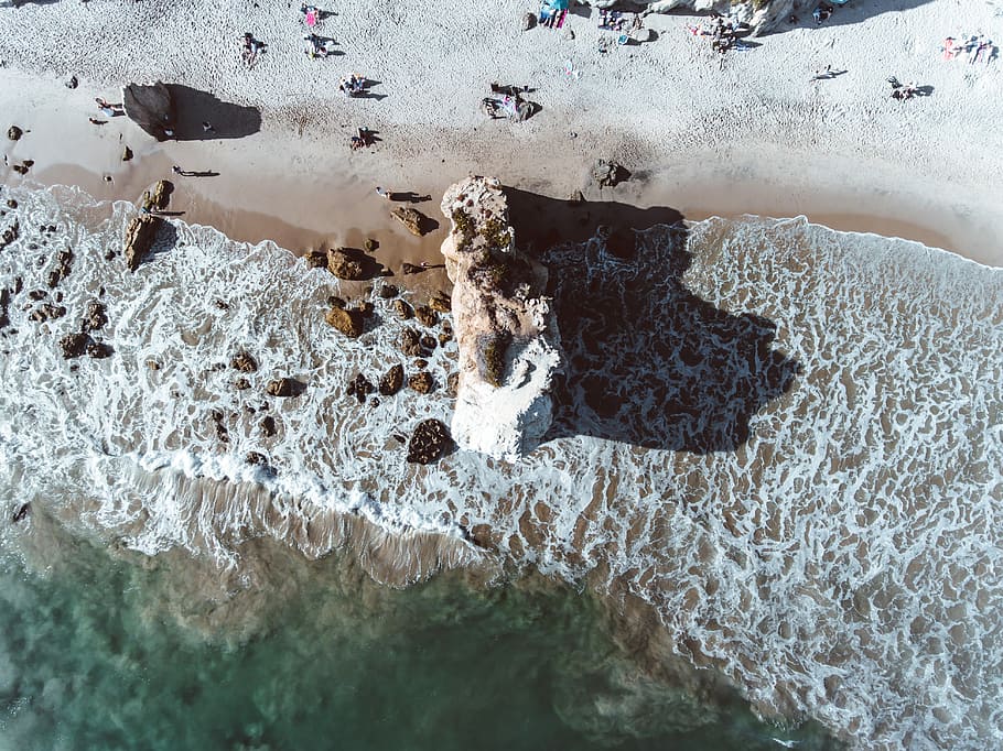 aerial view of body of water, aerial photography of rock near sea at daytime HD wallpaper
