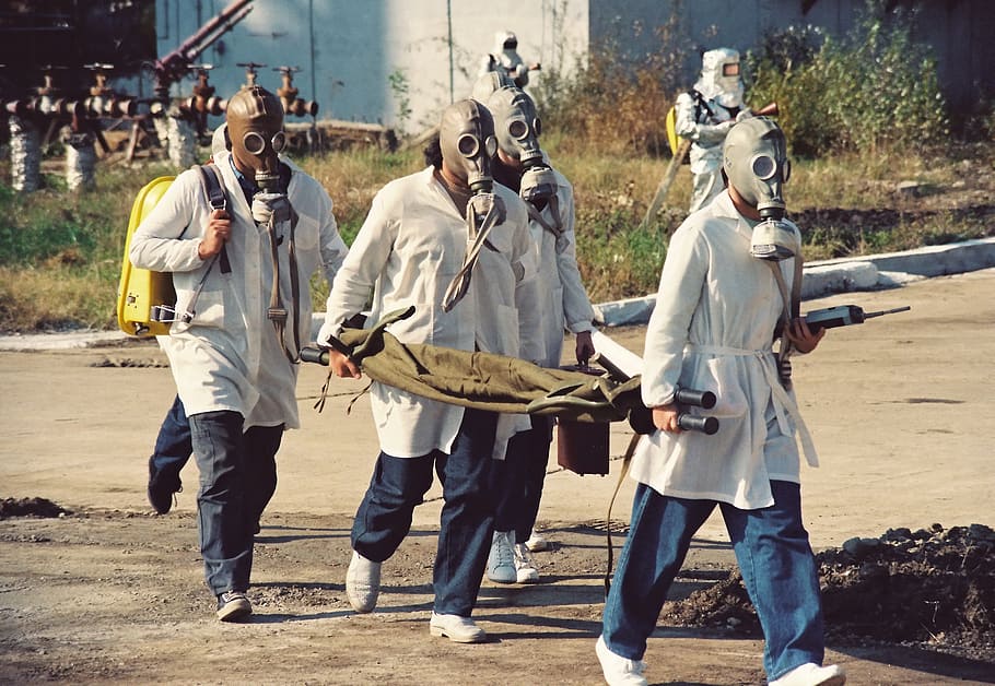 four men wearing brown gas masks, heavy water factory, chemical disaster exercise