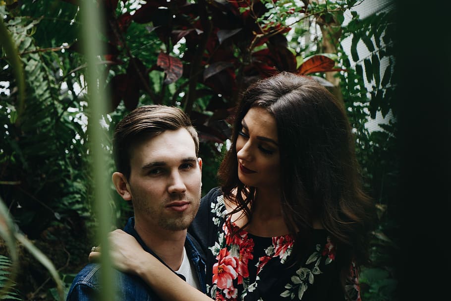 man in blue top carrying woman in floral top, woman hugging man HD wallpaper