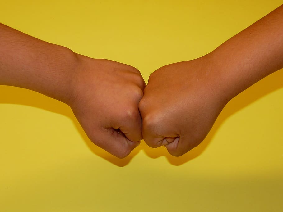 close-up photo of two human fists on yellow surface, faust HD wallpaper