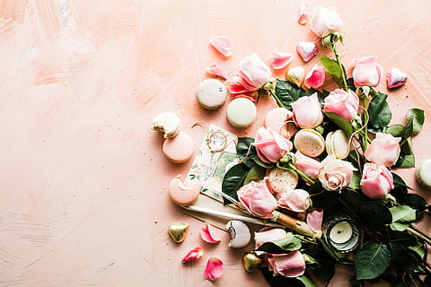 flat-lay photography of macaroons and pink rose flowers, pink roses with cookies on peach surface HD wallpaper