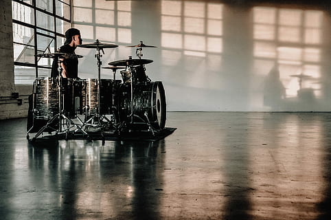 person in front of drumset, man's playing drum instrument, warehouse HD wallpaper