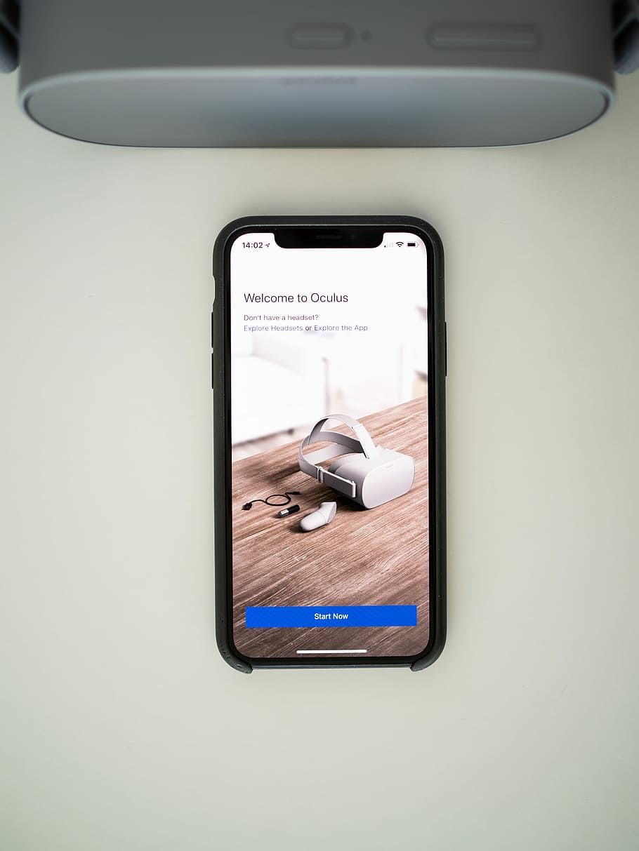 iPhone displaying Welcome to Oculus, black smartphone beside gray speaker, HD wallpaper