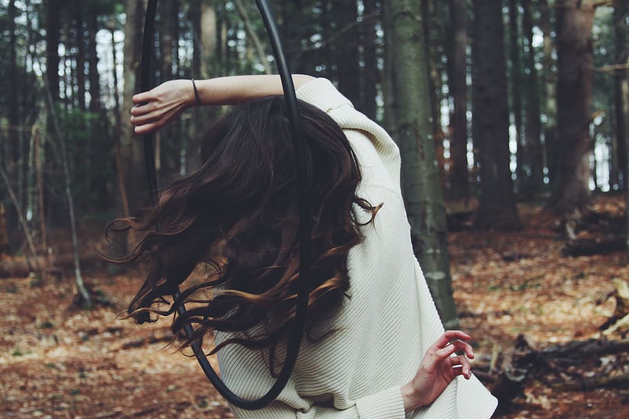person raising her hand, woman in gray sweater holding hula hoop in forest, HD wallpaper