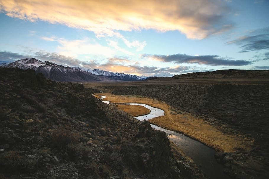 aerial photography of body of water, aerial photo of river beside rocky mountain and valley at daytime HD wallpaper