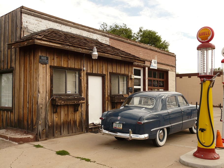 blue sedan parked beside brown wooden house at daytime, petrol stations HD wallpaper
