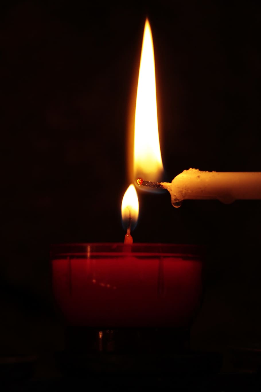 closeup photo of lighted candles, tealight, hand, church, prayer