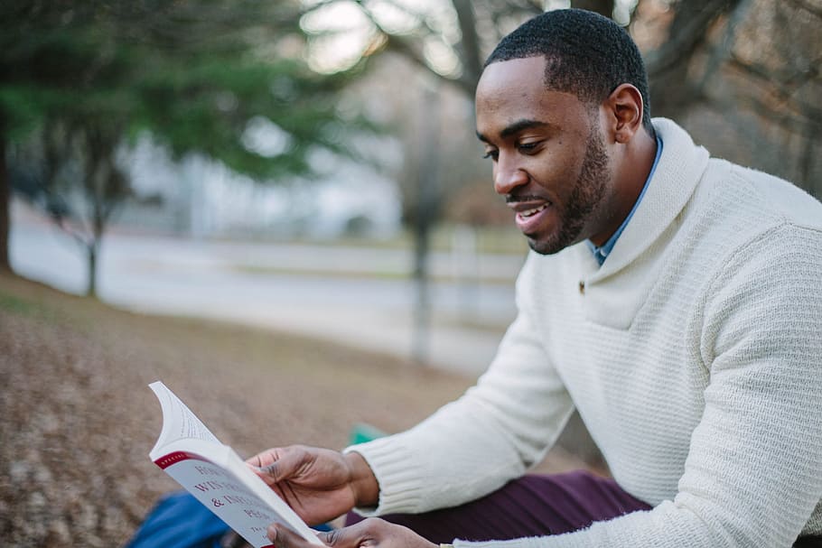 man wears white sweater and reading a book, people, guy, smile HD wallpaper