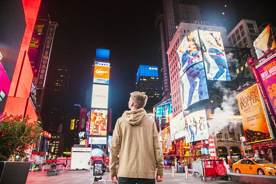 man standing on road infront of high-rise buildi, man standing in New York Times Square