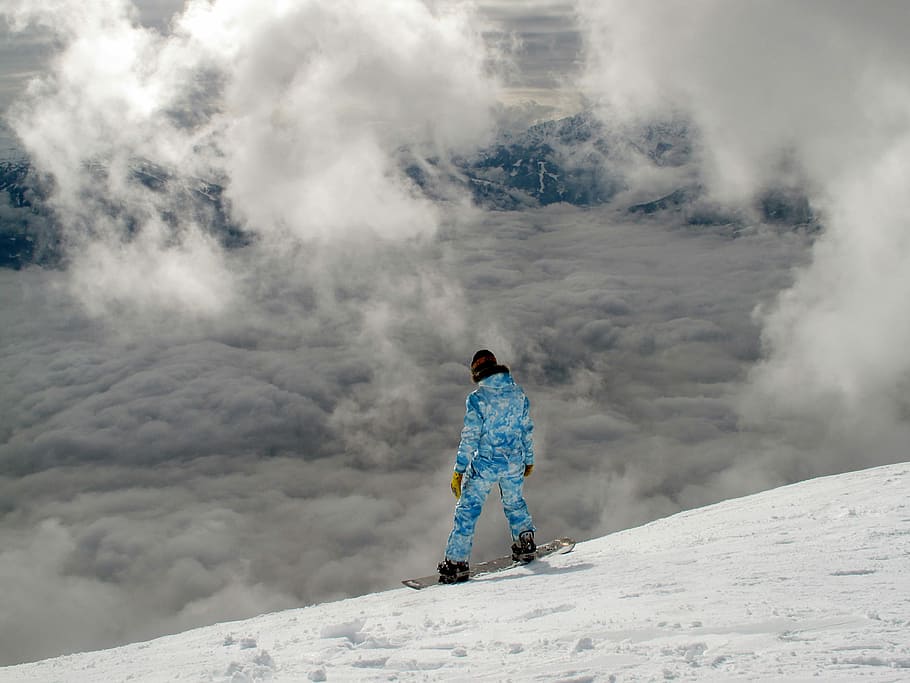 person wearing blue ski uit with board on top of snowy mountain HD wallpaper