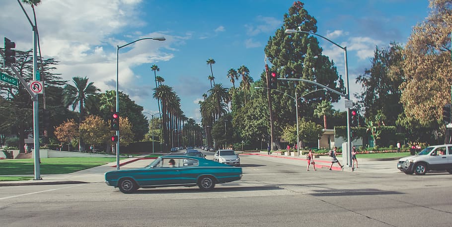 teal car on gray concrete road, people walking on pedestrian lane near cars at daytime HD wallpaper