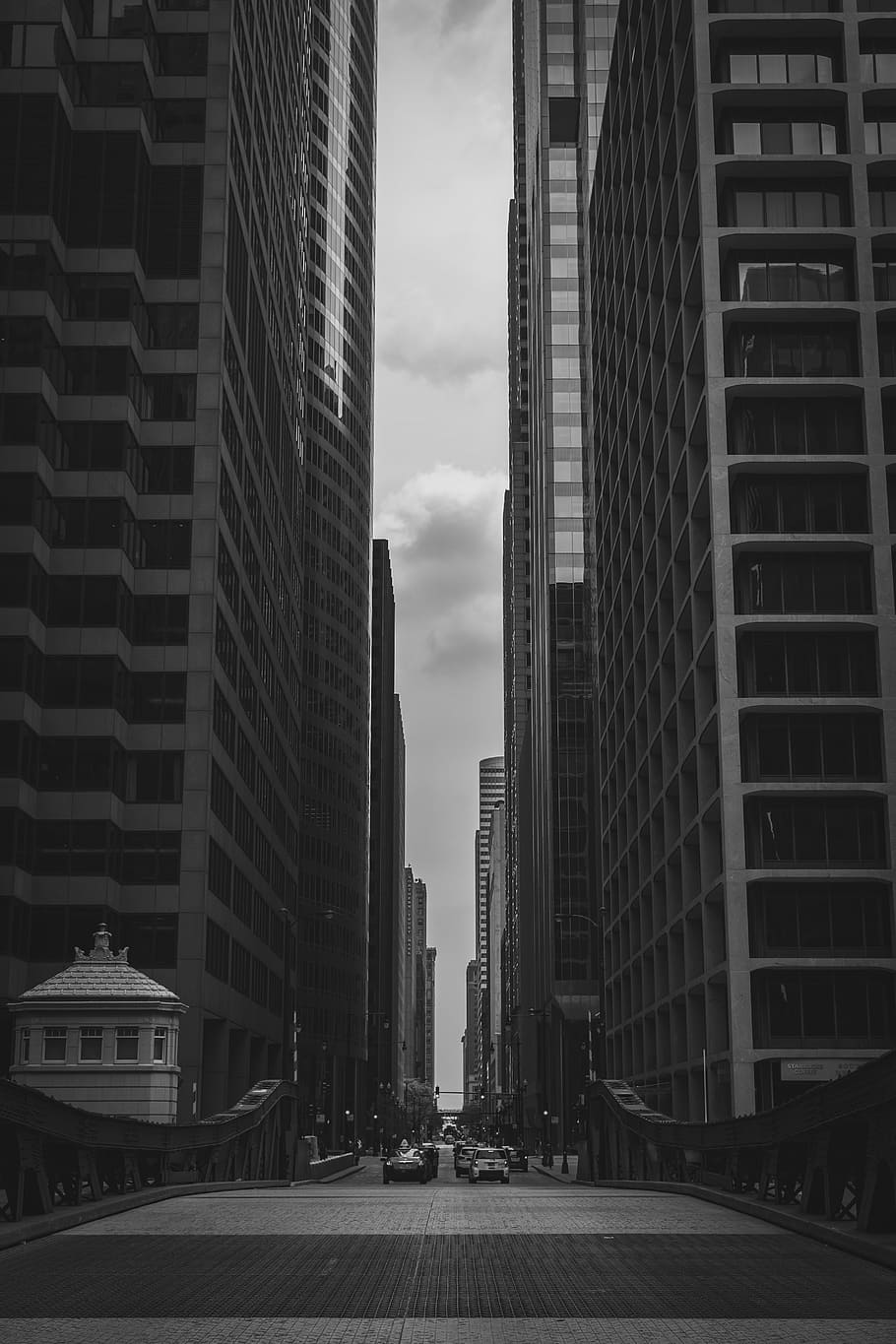 grayscale photograpy of a road between man-made structures HD wallpaper