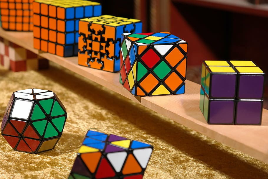 assorted-color-and-shape Rubik's cube lot on shelf, magic cube, HD wallpaper