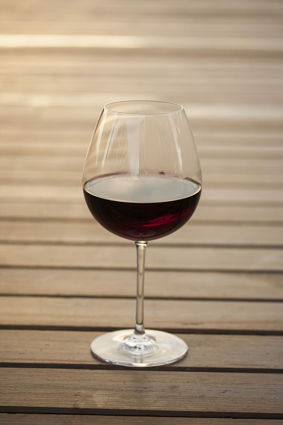 selective focus photography of wine glass filled with red beverage on brown wooden surface, HD wallpaper