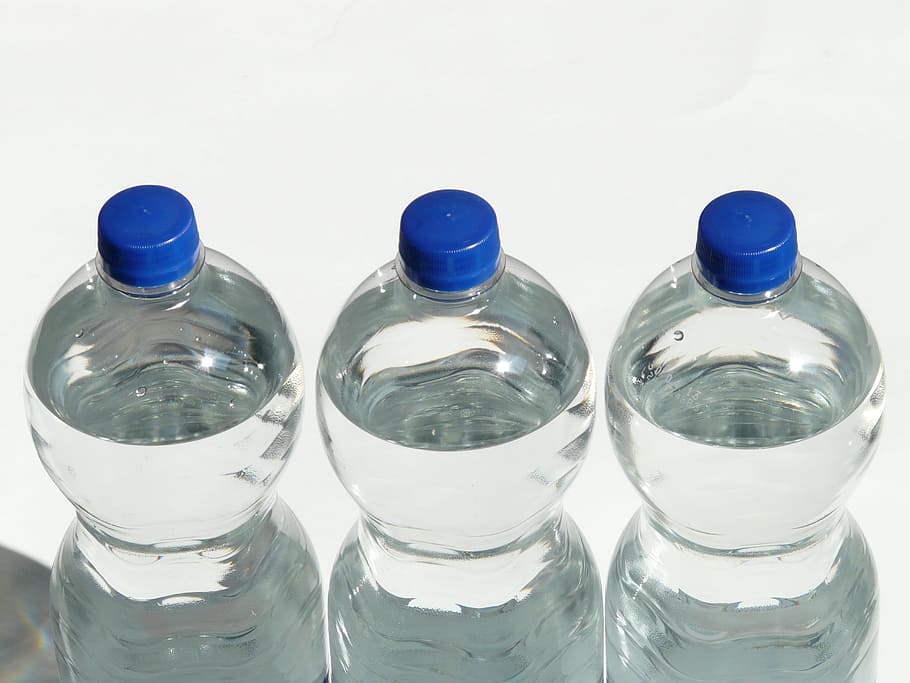 shallow photography of three clear plastic bottles, water bottles