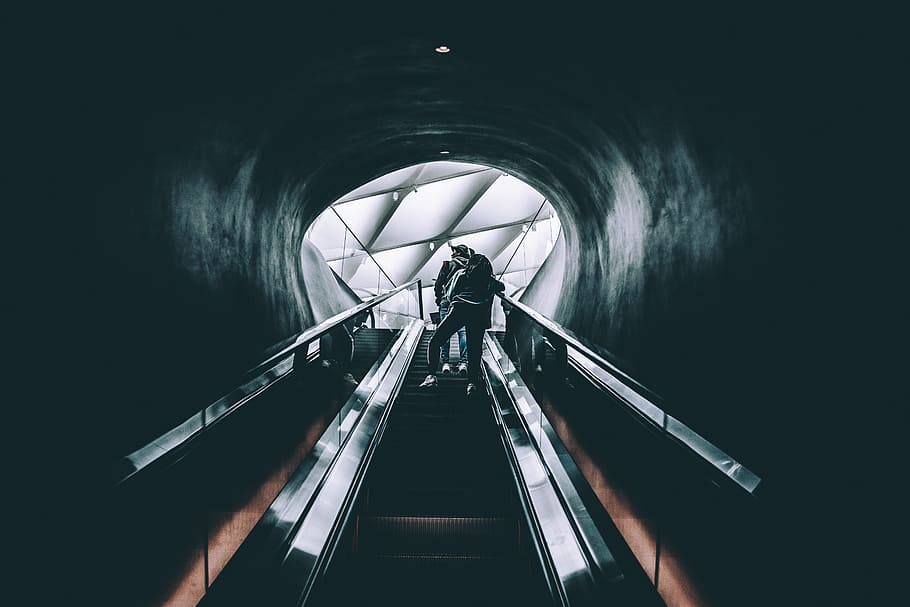 person standing on escalator, silhouette of two persons riding skalator HD wallpaper