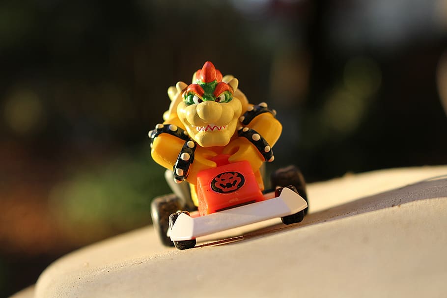 selective focus photo of Super Mario Bowser toy, kart, sun, fictional person