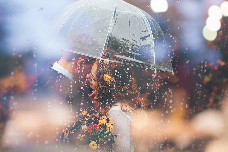 photo of woman hugging man under clear umbrella, couple about to kiss under umbrella HD wallpaper