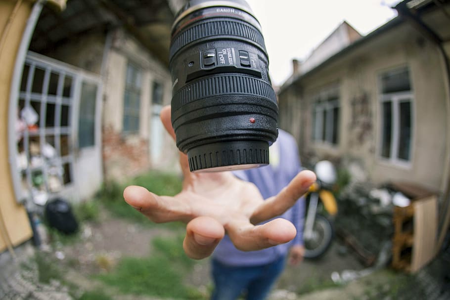 black camera lens, person, hand, daytime, people, man, house HD wallpaper