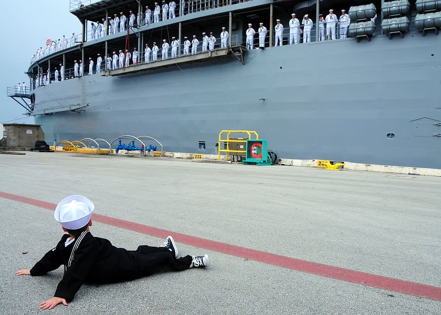 boy sitting at dock looking on a ship with marines in it, navy suit HD wallpaper