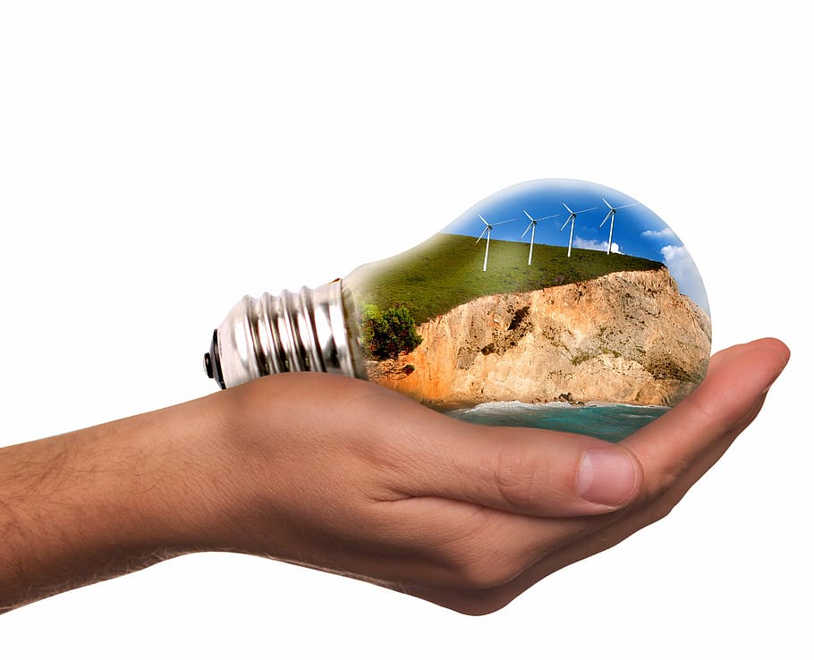 light bulb on person's right hand, pinwheel, energy revolution