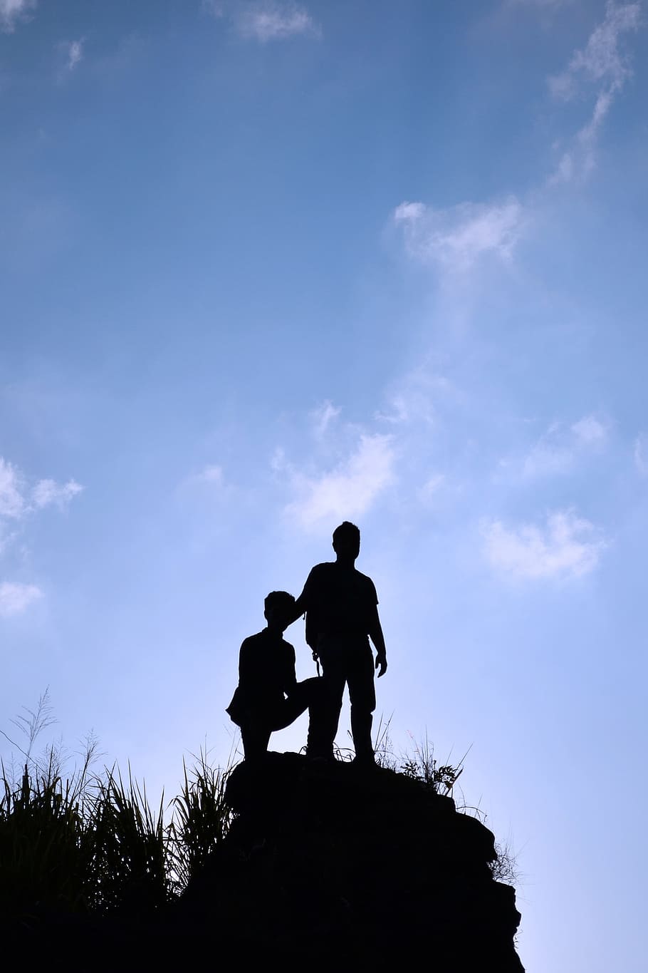 silhouette photo of two boy standing on heels under blue sky, HD wallpaper