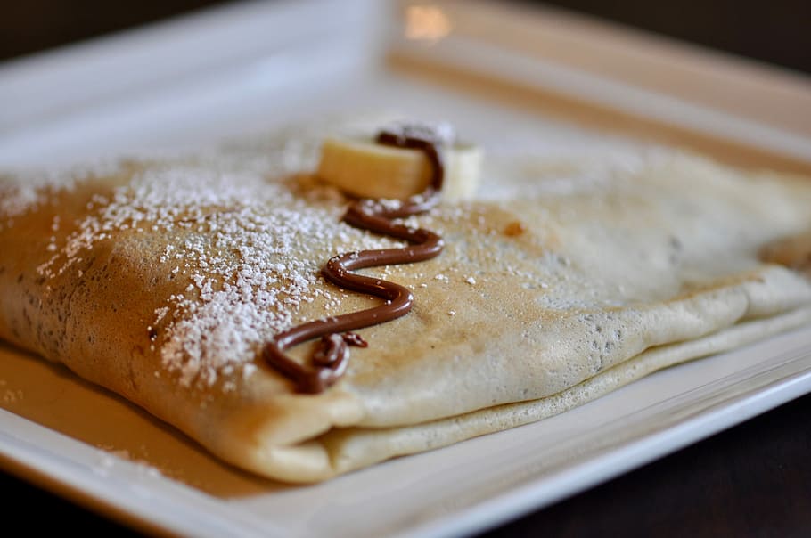 chocolate syrup on baked pastry, white ceramic plate, food, crepe