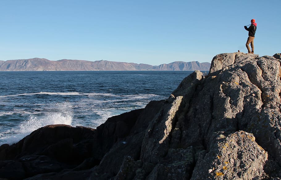 mountain, rocks, people, man, waves, ocean, sea, water, clouds HD wallpaper