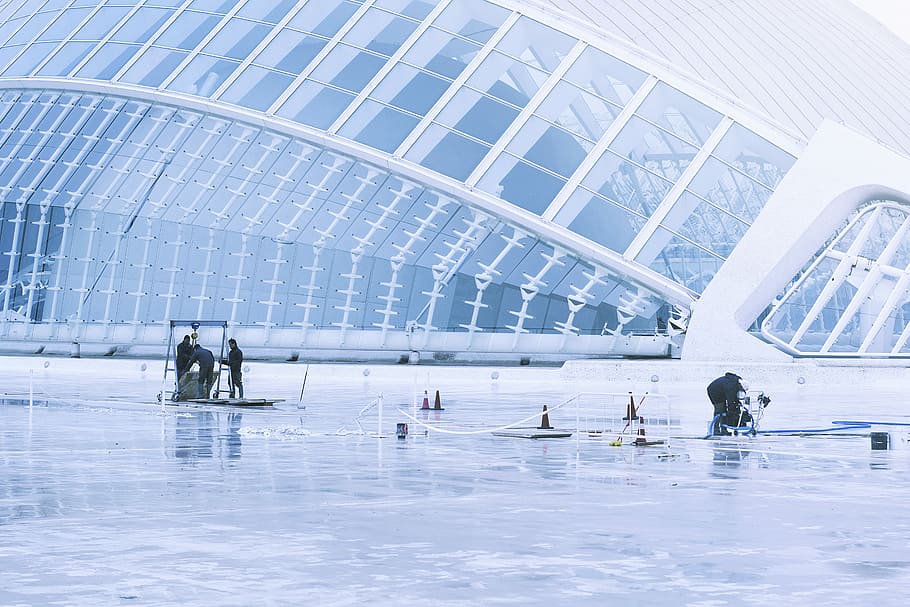 people inside white building, people standing on snow-covered field during daytime HD wallpaper