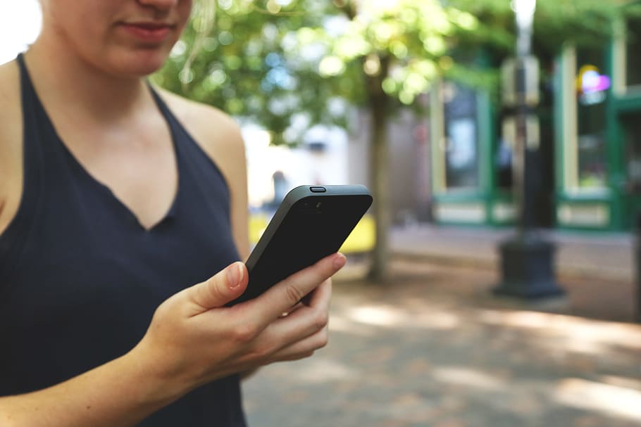 woman holding smartphone, mobile, technology, cellphone, communication HD wallpaper