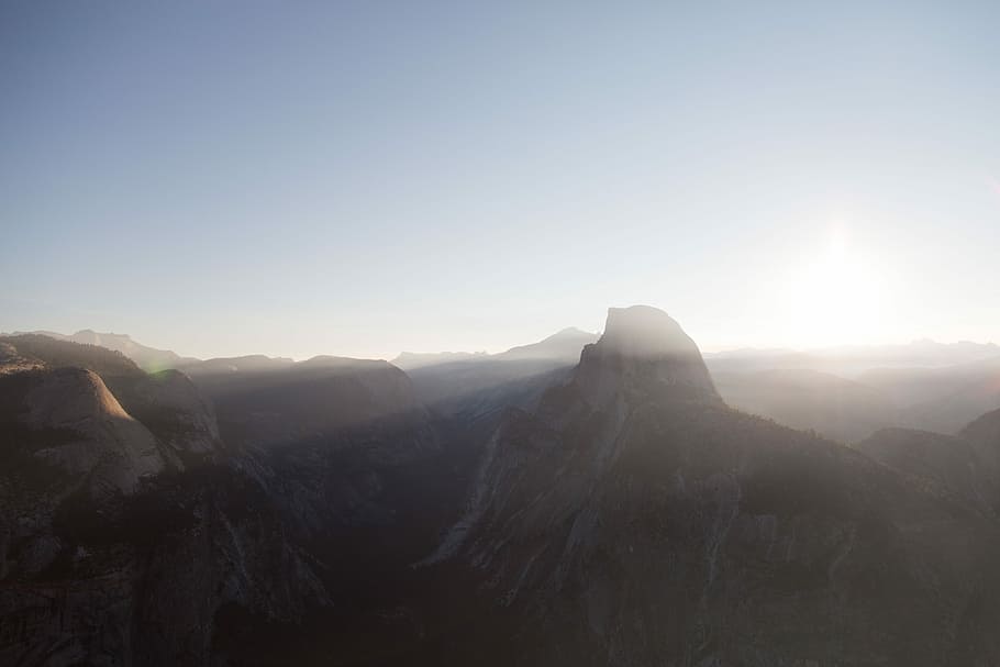 mountains during daytime, silhouette of mountain with sun rays HD wallpaper