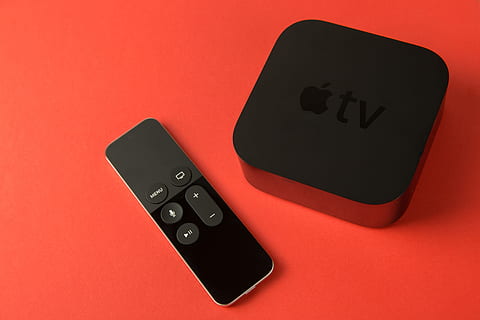 Overhead shot of the 4th generation Apple TV media player and touch remote control HD wallpaper