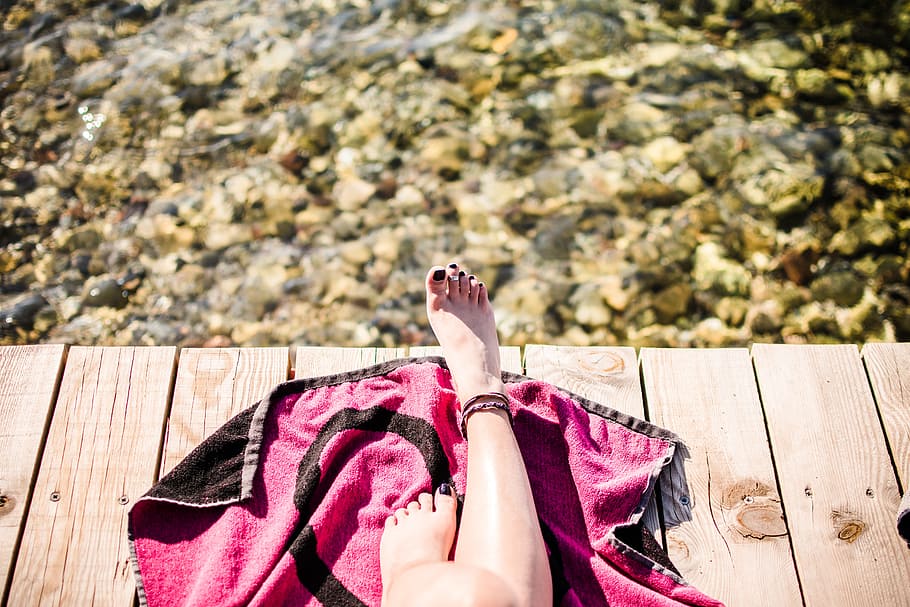 person on black and pink tapestry, woman on brown wooden deck, HD wallpaper