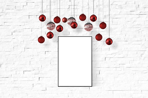 red Christmas baubles hanging behind white painted surface HD wallpaper