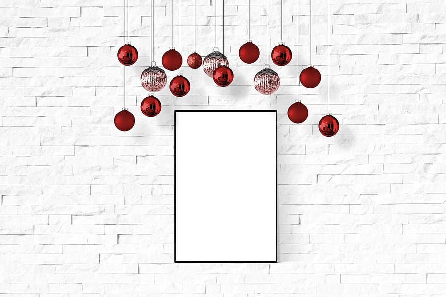red Christmas baubles hanging behind white painted surface HD wallpaper