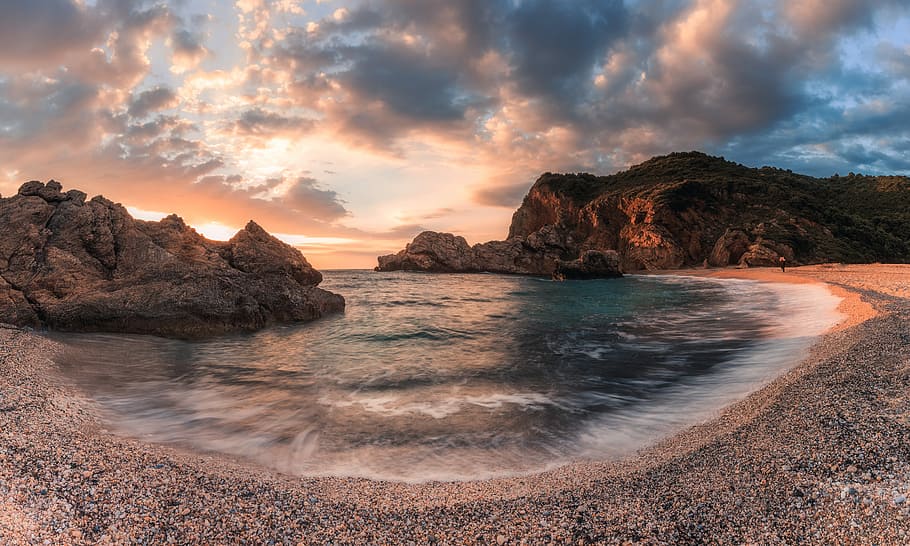 seashore near rock formation at golden hour, seashore with rock formation under gray clouds during daytime HD wallpaper