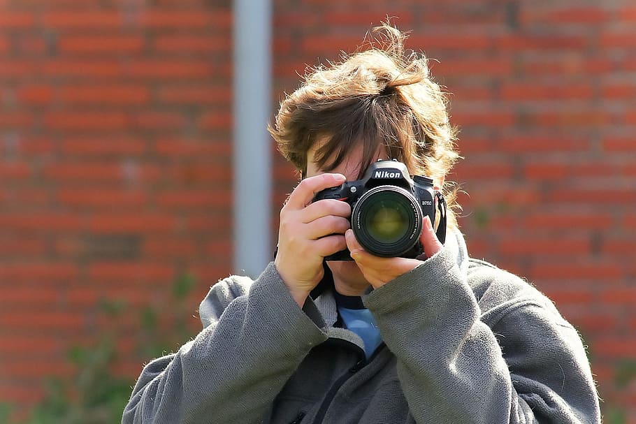 person holding DSLR camera, woman, photographer, lens, human