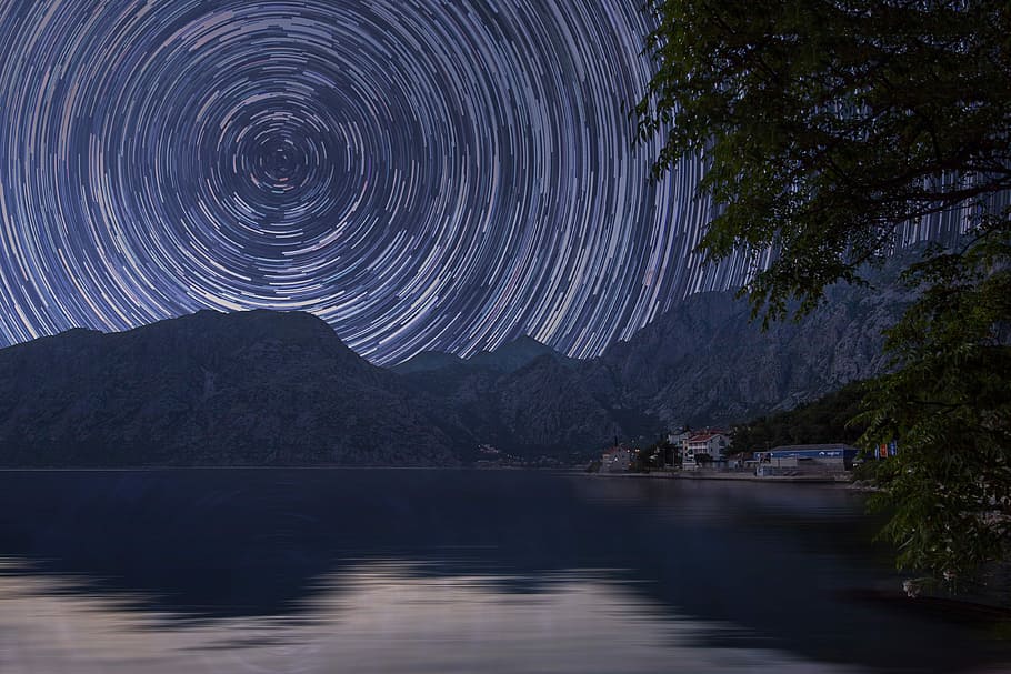 bodies of water near mountain at starry night, time laps photography of stars HD wallpaper