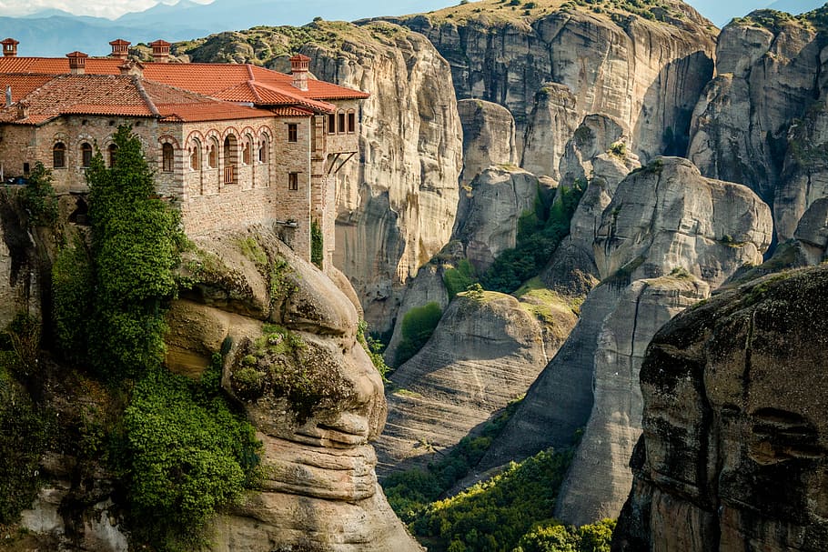 aerial view of orange brick castle near steep rock cliff, panoramic photography of castle on top of cliff HD wallpaper