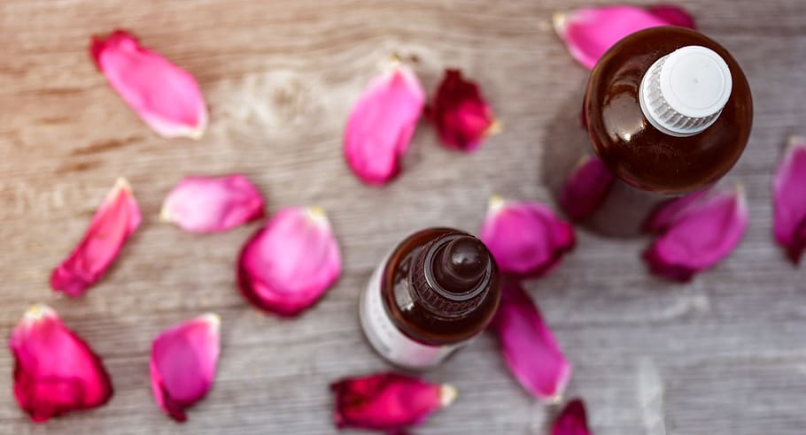 two amber glasses with pink rose petals, essential oils, alternative HD wallpaper
