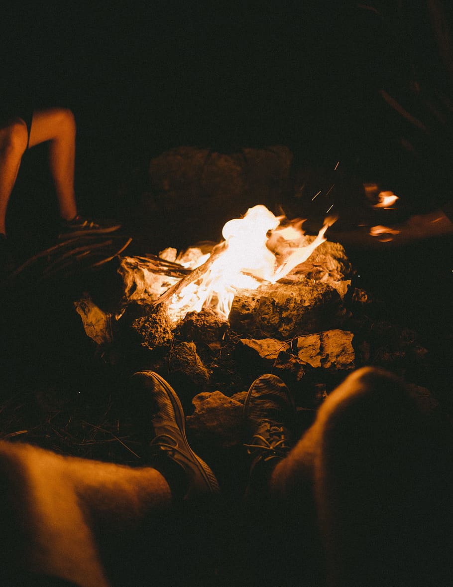 Group of People Sitting Beside the Bonfire during Night Time HD wallpaper