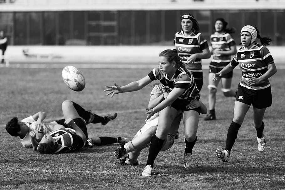 grayscale photo of a woman playing soccer, grayscale photo of women playing rugby football