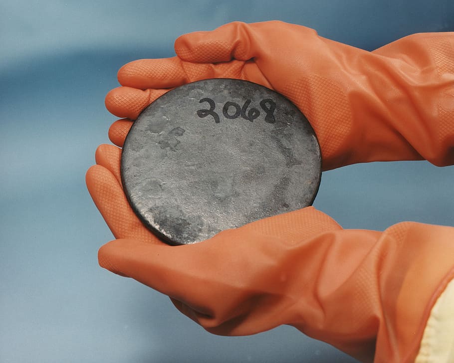 person holding gray steel emblem, Uranium, Radioactive, Nuclear HD wallpaper