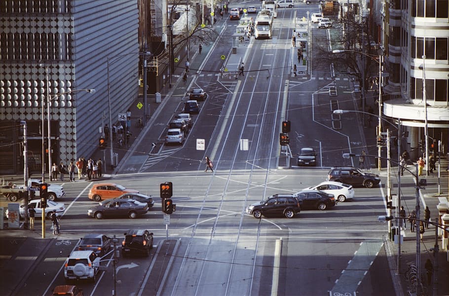 vehicle traveling near buildings during daytime, intersection HD wallpaper