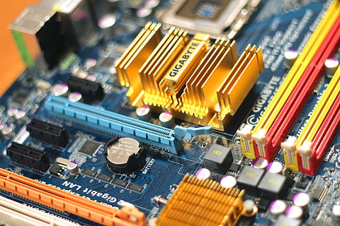 On this photo a computer mainboard manufactured by Gigabyte is visible. It features different sockets, connectors, coolers, heatpipes, the mainboard battery, DDR memory ram slots and the processor socket. HD wallpaper