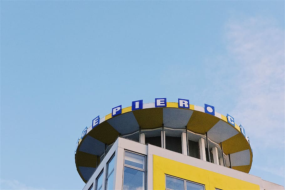 yellow and white pier building under clear skies, seaside, arcade HD wallpaper